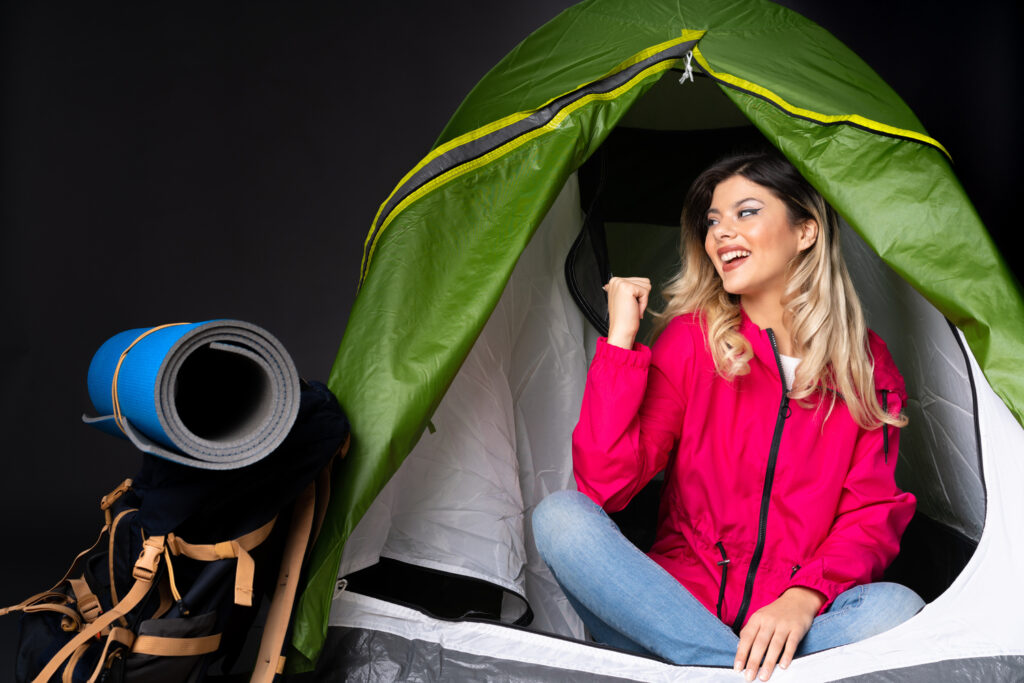 Teenager Girl Inside Camping Green Tent Black Wall Pointing Up Surprised1 1024x683